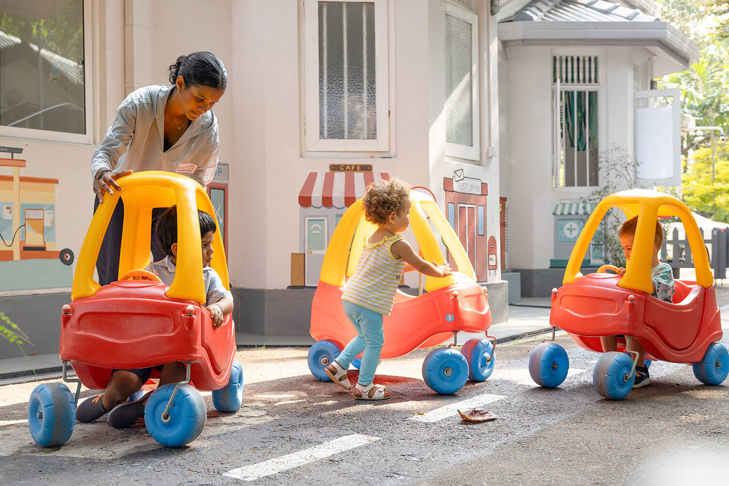 Children playing on carts at The American Preschool, Colombo